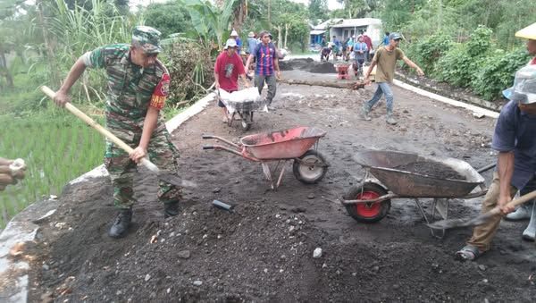 Tumbuhkan Jiwa Gotong Royong, Babinsa Sinergi Bantu Penimbunan Jalan Desa
